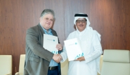 Director-General of the Qatar Press Centre Sadiq Mohammed Al Amari, and Head of the Gulf and Arabian Peninsula Studies Unit at the Arab Center for Research and Policy Studies, Dr. Haider Saeed during the singing ceremony.