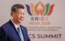 In this pool photograph distributed by the Russian state agency Sputnik, China's President Xi Jinping arrives before the start of the 18th BRICS Summit in New Delhi on September 12, 2026. (Photo by Alexander Kazakov / Pool / AFP)