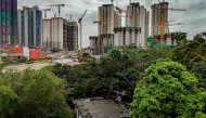 An aerial view shows the home of Kwu Tung resident Niki So in the foreground, as surrounding land is transformed into construction sites under Hong Kong's Northern Metropolis development plan, in Hong Kong, on June 17, 2026. (Photo by Leung Man Hei / AFP)