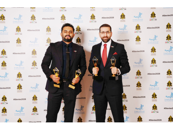 Ahmed Alkahlout and Fajir Abdul Majeed pose with the awards during the ceremony.