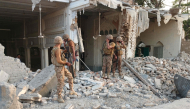Army personnel stand amid the rubble following an explosion inside the police headquarters at Kohat in Pakistan's Khyber Pakhtunkhwa province on September 18, 2026. (Photo by Basit Shah / AFP)
