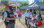 A member of the Mexican National Guard makes an announcement to residents and visitors about the approach of Hurricane Polo along a beach in Acapulco, Guerrero state, Mexico, on September 21, 2026. (Photo by Francisco Robles / AFP)