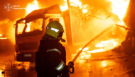 This handout picture, taken and released by Ukrainian State Emergency Service, shows a firefighter extinguishing a fire in a production workshop, following a aerial attack in Odesa region, amid the Russian invasion of Ukraine, on September 27, 2026. (Photo by Handout / Ukrainian State Emergency Service / AFP)
