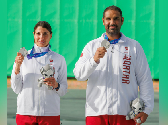 Qatar's Ray Bassil and Mohammed Al-Rumaihi celebrate with their medals on the podium. 