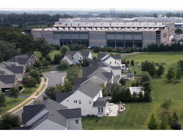 This aerial view shows an Amazon Web Services (AWS) data center adjacent to single-family homes in Stone Ridge, Virginia on August 12, 2026. Photo by Brendan Smialowski / AFP