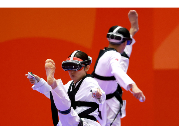 Japan's Nakajima Miho (L) competes against compatriot Suzuki Hayate (R) in the mixed individual virtual taekwondo round 16 during the 2026 Asian Games at the Toyohashi Gymnasium in Toyohashi on October 2, 2026. (Photo by DAVID GRAY / AFP)