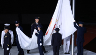 Members of the Japan Self-Defense Forces lower the Olympic Council of Asia (OCA) flag during the closing ceremony of the 2026 Asian Games at Nagoya City Mizuho Park Athletic Stadium in Nagoya, Aichi Prefecture on October 4, 2026. (Photo by David Gray / AFP)
