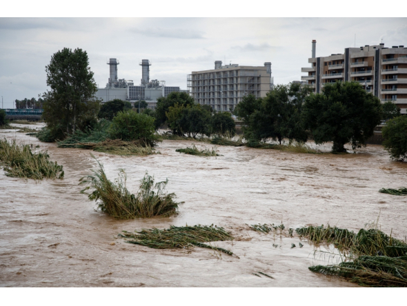 The swollen Besos River flows through Sant Adria de Besos following torrential rains on the outskirts of Barcelona, on October 4, 2026. (Photo by Josep Lago / AFP)