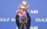 Race winner Red Bull Racing's Dutch driver Max Verstappen lifts his trophy during podium ceremony of the Formula One Bahrain Grand Prix in Sepang on October 4, 2026. (Photo by Jade Gao / AFP)