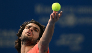 Spain's Carlos Alcaraz serves to compatriot Jaume Munar in their men's singles semi-final tennis match at the ATP Tour Japan Open Tennis Championships at the Ariake Tennis Forest Park in Tokyo on October 5, 2026. (Photo by Rie KIKUCHI / AFP)