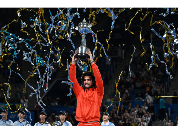 Spain's Carlos Alcaraz holds the trophy as he celebrates beating Czech Republic's Jiri Lehecka in the men's singles final during the Japan Open tennis tournament at the Ariake Tennis Forest Park in Tokyo on October 6, 2026. (Photo by Rie KIKUCHI / AFP)