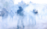 Police officers stand in the smoke during a demonstration of high-school students, in Paris on October 6, 2026, as part of a nationwide protest movement over learning conditions. (Photo by Kenzo TRIBOUILLARD / AFP)