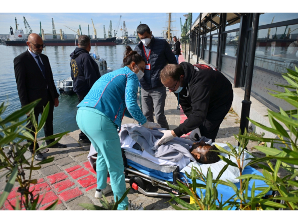 An injured crew member from a ship struck by drones in Bulgaria's exclusive economic zone is moved on a stretcher after he was rescued, at the Varna harbour on October 6, 2026.  (Photo by AFP)
 