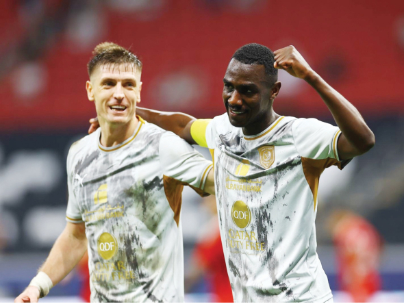 Al Duhail's Krzysztof Piatek (left) and Almoez Ali celebrate.