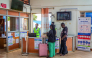 Travellers receive information from health officials near Ebola awareness posters before crossing the border at the Busia One Stop Border Post (OSBP) on the Kenya-Uganda border as health authorities step up Ebola screening measures, in Busia on October 12, 2026. (Photo by Bright Emoja / AFP)
