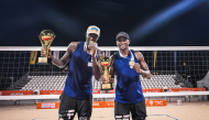 Qatar's Cherif Younousse (left) and Ahmed Tijan celebrate with their trophies.