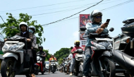 Motorcyclists queue to refuel at a gas station in Denpasar amid a fuel supply shortage on Indonesia's resort island of Bali on Oct 14, 2026. (Photo: AFP/Sonny Tumbelaka)