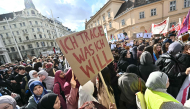 (Files) A protester holds a placard reading 