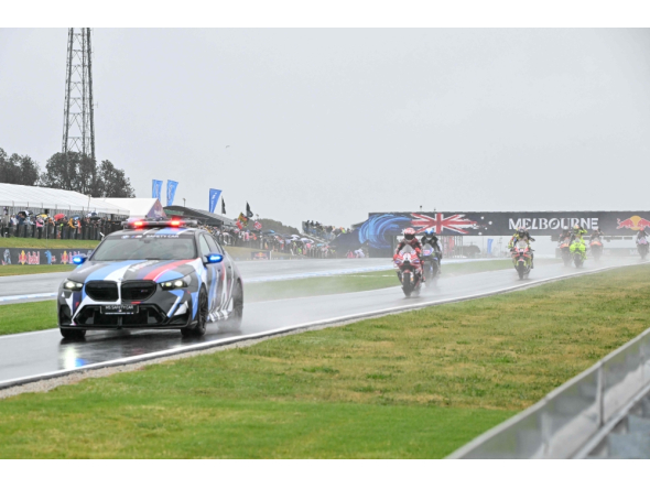The safety car leads MotoGP riders in a farewell lap following the cancellation of the last Australian MotoGP Grand Prix to be held at Phillip Island on October 25, 2026, due to inclement weather conditions. (Photo by Paul Crock / AFP)