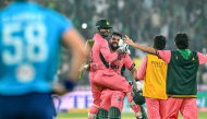 Pakistan's Shadab Khan (2L) and Haris Rauf (L) celebrate after their team's victory in the one-day international (ODI) tri-series cricket match against England at the Gaddafi Stadium in Lahore on October 25, 2026. (Photo by ARIF ALI / AFP)
