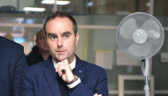 :France's Prime Minister Sebastien Lecornu (C) reacts at a police station during a visit to Limoges in the context of security and reconstruction efforts after a group of individuals forced entry into the building during last weekend's protest action against the 