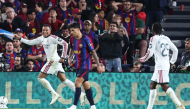 Real Madrid's French forward #10 Kylian Mbappe (L) celebrates scoring his team's first goal during the Spanish league football match between FC Barcelona and Real Madrid CF at Camp Nou Stadium in Barcelona on October 25, 2026. (Photo by Josep LAGO / AFP)