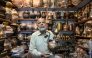 Antique dealer Ahsan Shakeel shows an artefact at his shop selling vintage items in Rawalpindi on October 20, 2026. Photo by Farooq Naeem / AFP
