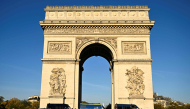 Gendarmes' vehicles surround the Arc de Triomphe in Paris on October 31, 2026. (Photo by Julien De Rosa / AFP)