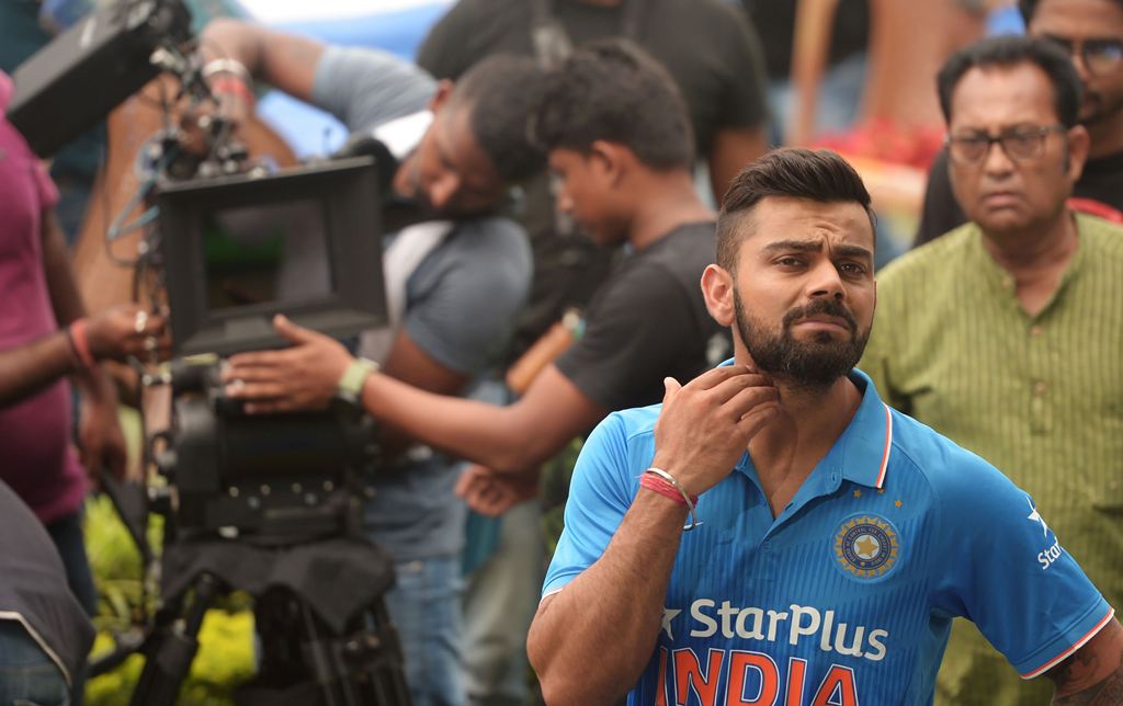 India's cricket captain Virat Kohli reacts during a promotional shoot prior to a training session in Kolkata on September 28, 2016. India take on the visiting New Zealand cricket team in the second Test of the series from September 30 - October 4. (AFP / 