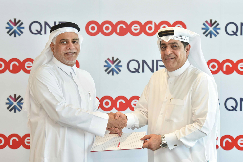 QNB and Ooredoo officials during agreement signing ceremony.