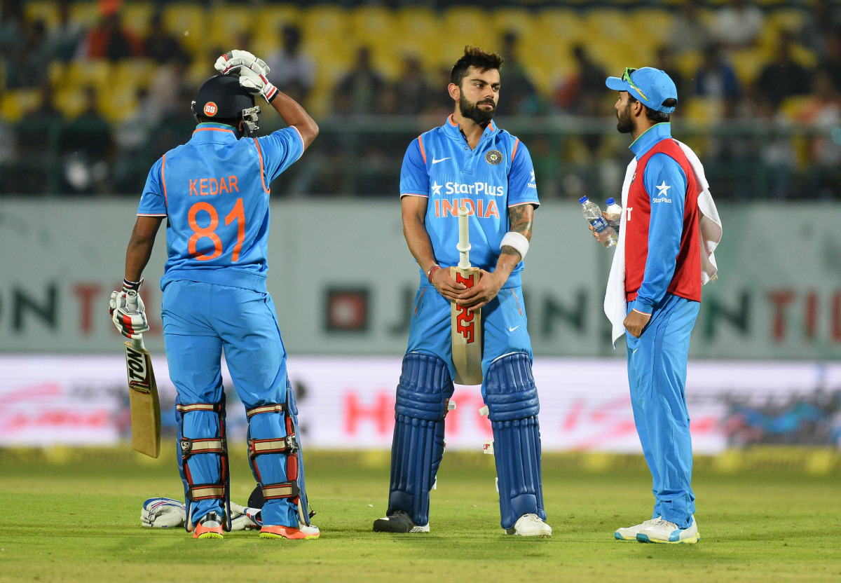 Indian batsman Virat Kohli holds his bat during a break at the first one day international match between India and New Zealand at The Himachal Pradesh Cricket Association Stadium (HPCA) in Dharamsala on October 16, 2016. (AFP / Sajjad HUSSAIN)