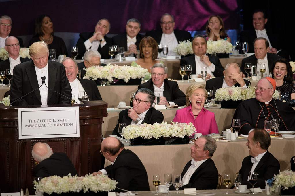 Democratic presidential nominee Hillary Clinton laughs at as Republican presidential nominee Donald Trump tells a joke during the Alfred E. Smith Memorial Foundation Dinner at Waldorf Astoria October 20, 2016 in New York. AFP / Brendan Smialowski