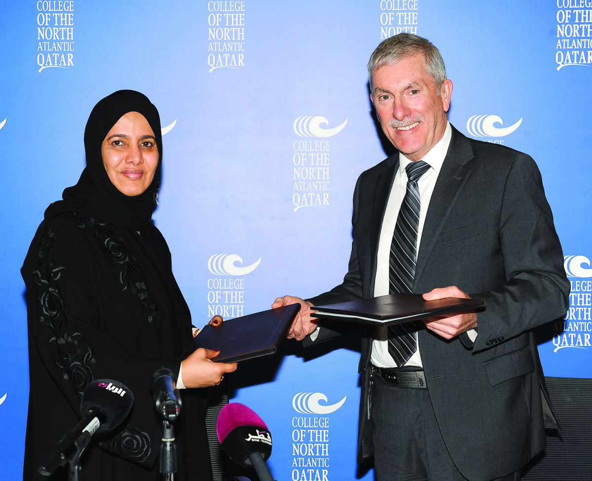 Secretary-General of Qatar National Commission for Education Culture and Science, Dr Hamda Hassan Al Sulaiti (left), and President of College of North Atlantic-Qatar (CNA-Q), Dr Ken MacLeod, exchanging documents after signing the deal yesterday.  (Pic: Sa