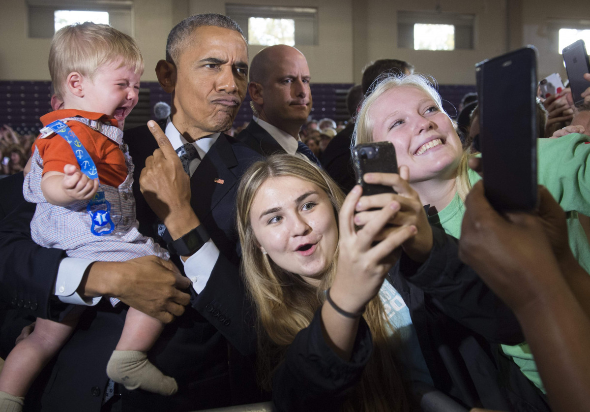 US President Barack Obama holds 10-month-old Brooks Breitwieser as he greets supporters after speaking to an overflow room during a Hillary for America campaign event for Democratic Presidential nominee Hillary Clinton at the Capital University Field Hous