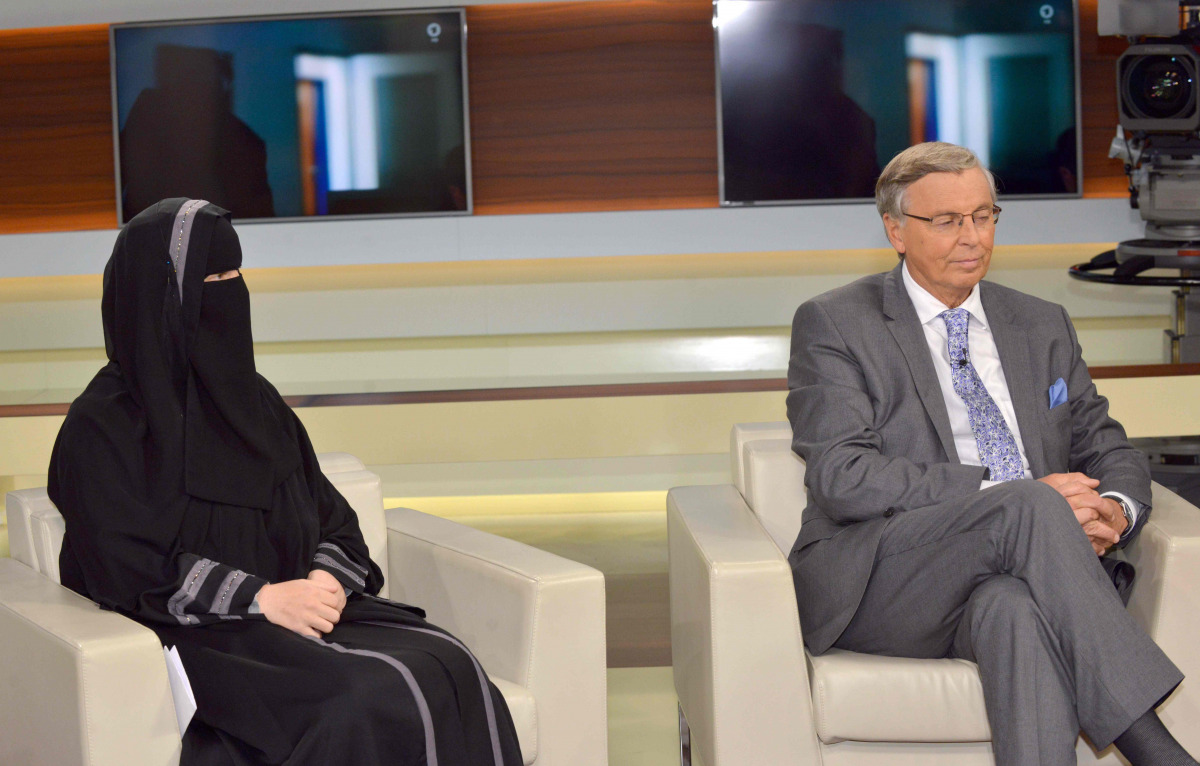 Nora Illi (L), the women's representative of an unofficial group called the Islamic Central Committee of Switzerland, wears a niqab as she attends along with Wolfgang Bosbach, lawmaker from Chancellor Angela Merkel's Christian Democratic Union party, a Su