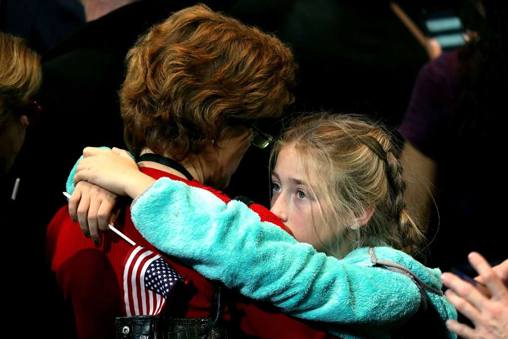 A girl hugs a woman as she watches voting results at Democratic presidential nominee former Secretary of State Hillary Clinton's election night event at the Jacob K. Javits Convention Center November 8, 2016 in New York City. John Moore/Getty Images/AFP