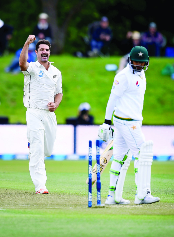 New Zealand's Colin de Grandhomme (left) celebrates after bowling out Pakistan's Azhar Ali during day two of their first Test match at the Hagley Park in Christchurch yesterday.