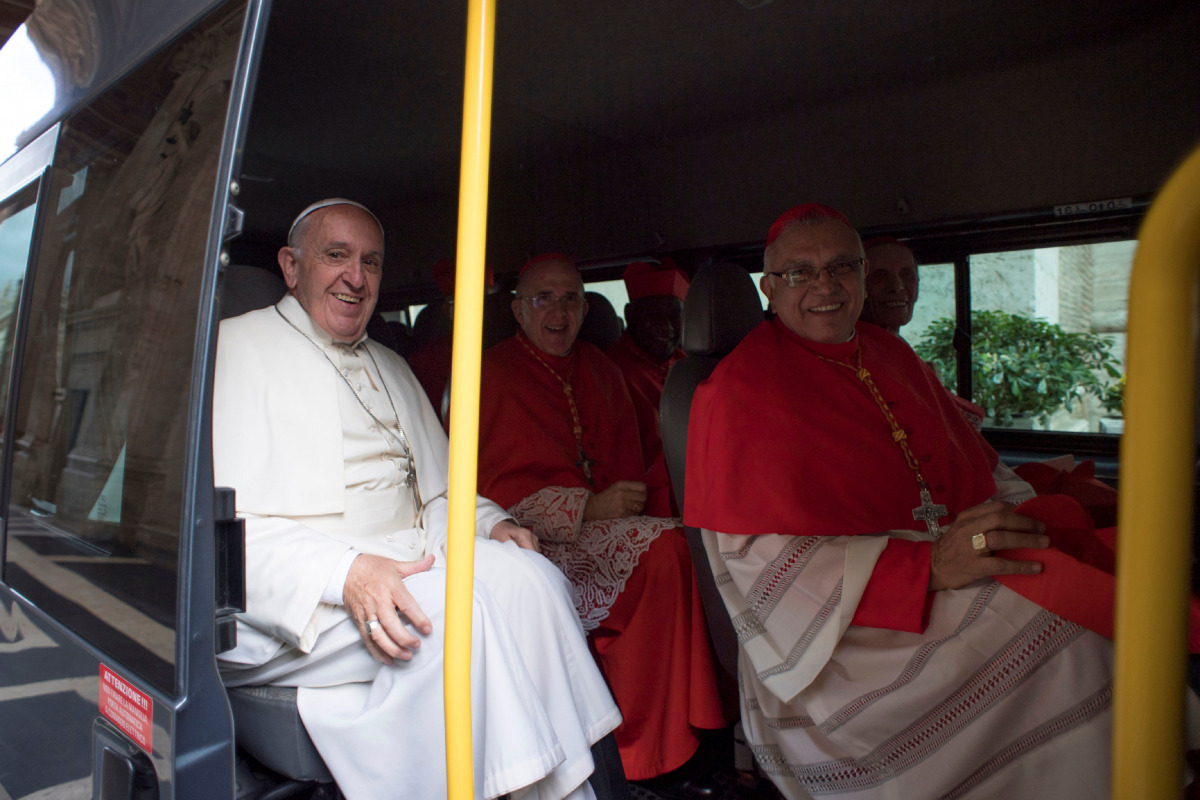 Pope Francis sits in a bus with the new cardinals as they travel to meet Pope Emeritus Benedict XVI following a consistory ceremony in Saint Peter's Basilica at the Vatican November 19, 2016. (Osservatore Romano Handout via Reuters)