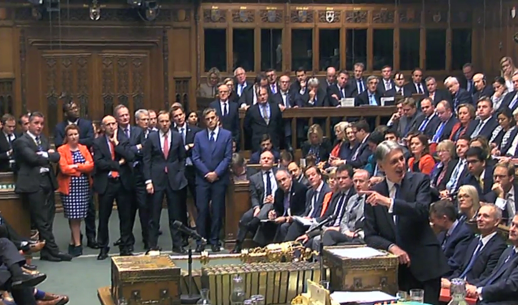 A video grab from footage broadcast by the UK Parliament's Parliamentary Recording Unit (PRU) shows British Chancellor of the Exchequer Philip Hammond as he stands at the distpatch box and speaks in the House of Commons in London on November 23, 2016.  AF