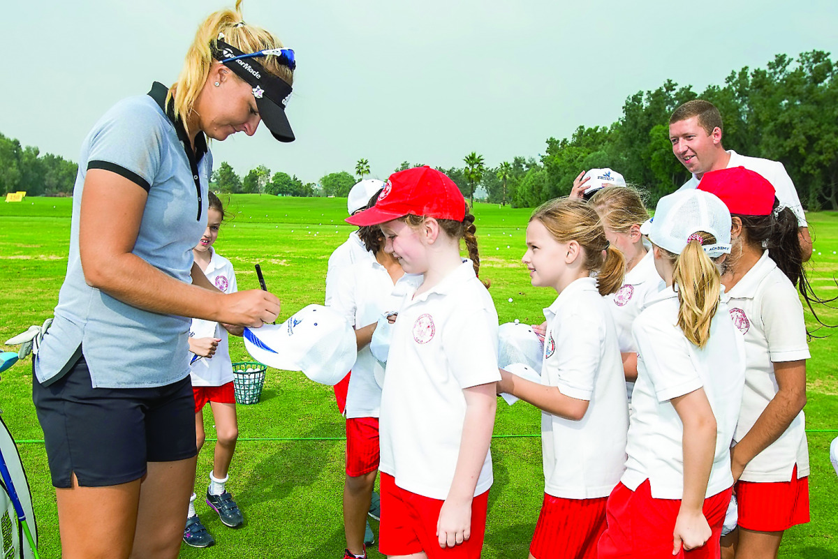Swedish golfer Anna Nordqvist signs autographs during a coaching clinic for local children on the driving range at the Doha Golf Club yesterday.
