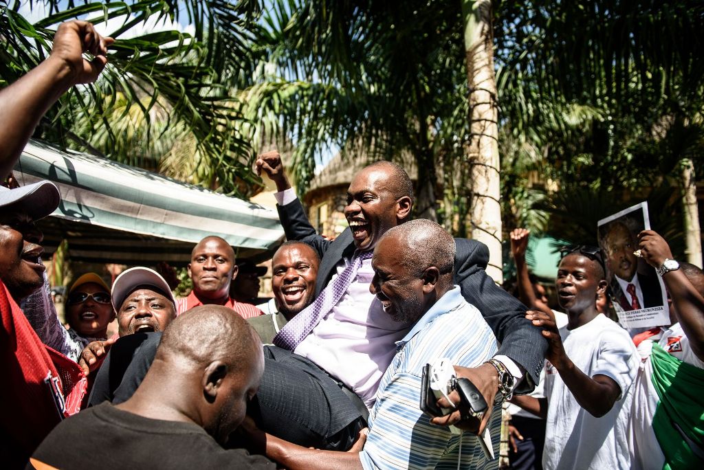 (FILES) This file photo taken on May 15, 2015 shows presidential spokesperson Willy Nyamitwe (C) being carried by supporters as people celebrate the return of the Burundian president after a failed coup attempt in the Kamenge quarter of Bujumbura, a rulin