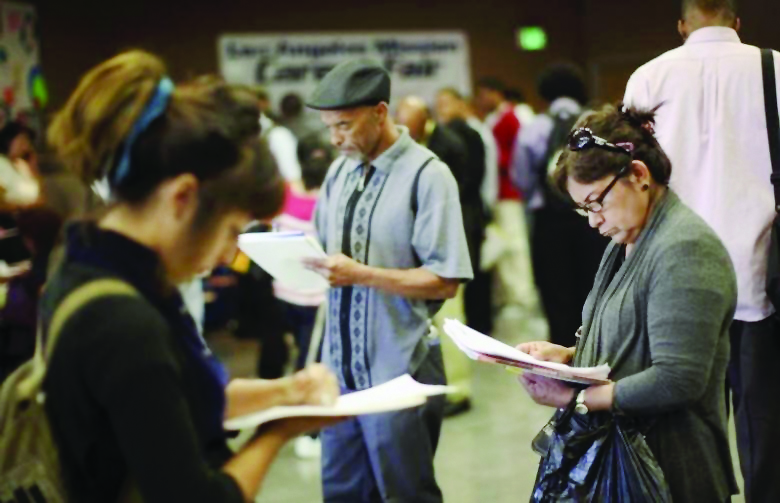 Job seekers fill out applications during the 11th annual Skid Row Career Fair the Los Angeles Mission in Los Angeles, California, US