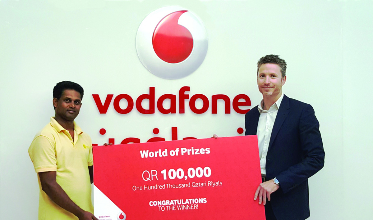 Vodafone's Luke Longney (right) handing over the prize.