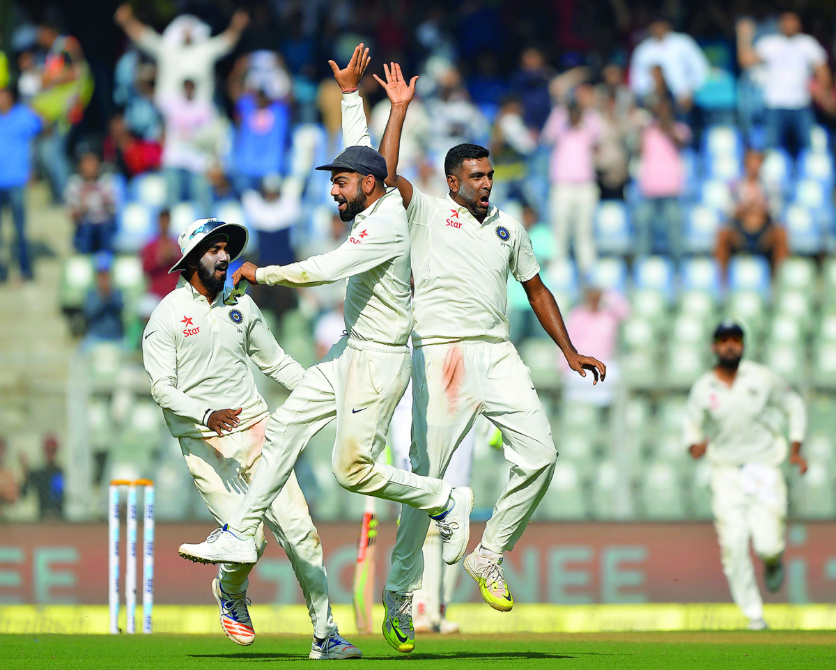 Indian skipper Virat Kohli (centre) celebrates with Ravichandran Ashwin (right) after Jennings' dismissal.