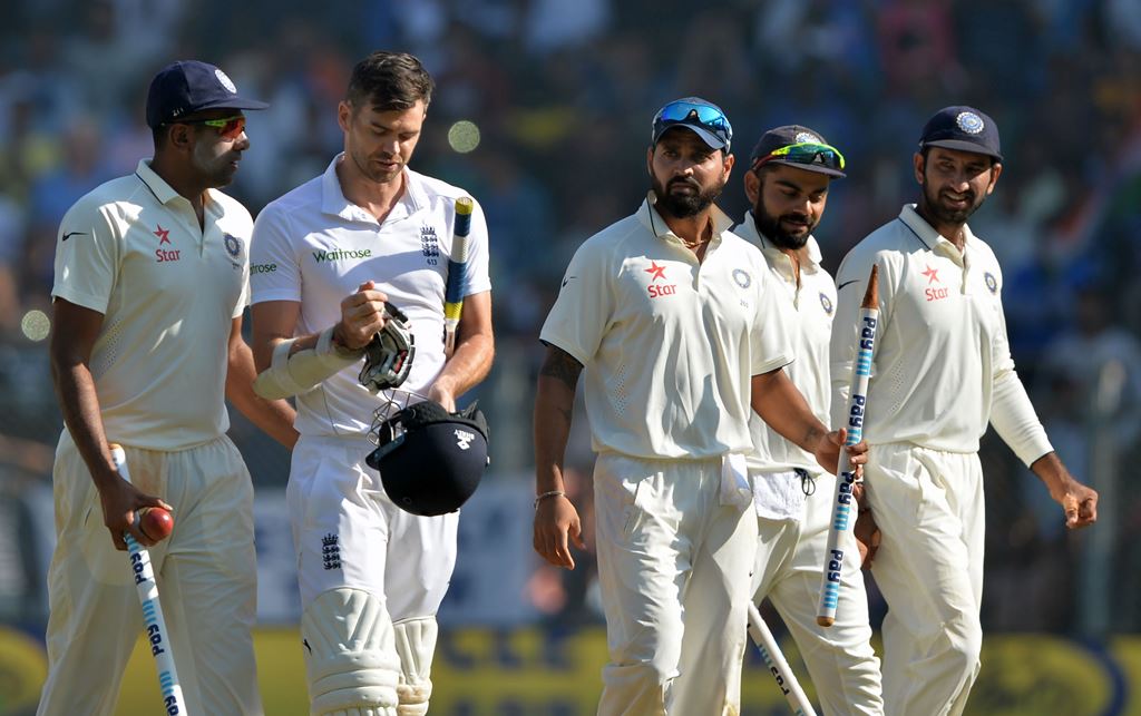 India's Ravichandran Ashwin (L) speaks with England's James Anderson (2nd L) as India's Murali Vijay (C), captain Virat Kohli (2nd R) and Cheteshwar Pujara (R) watch after India won the fourth Test cricket match against England at the Wankhede stadium in 