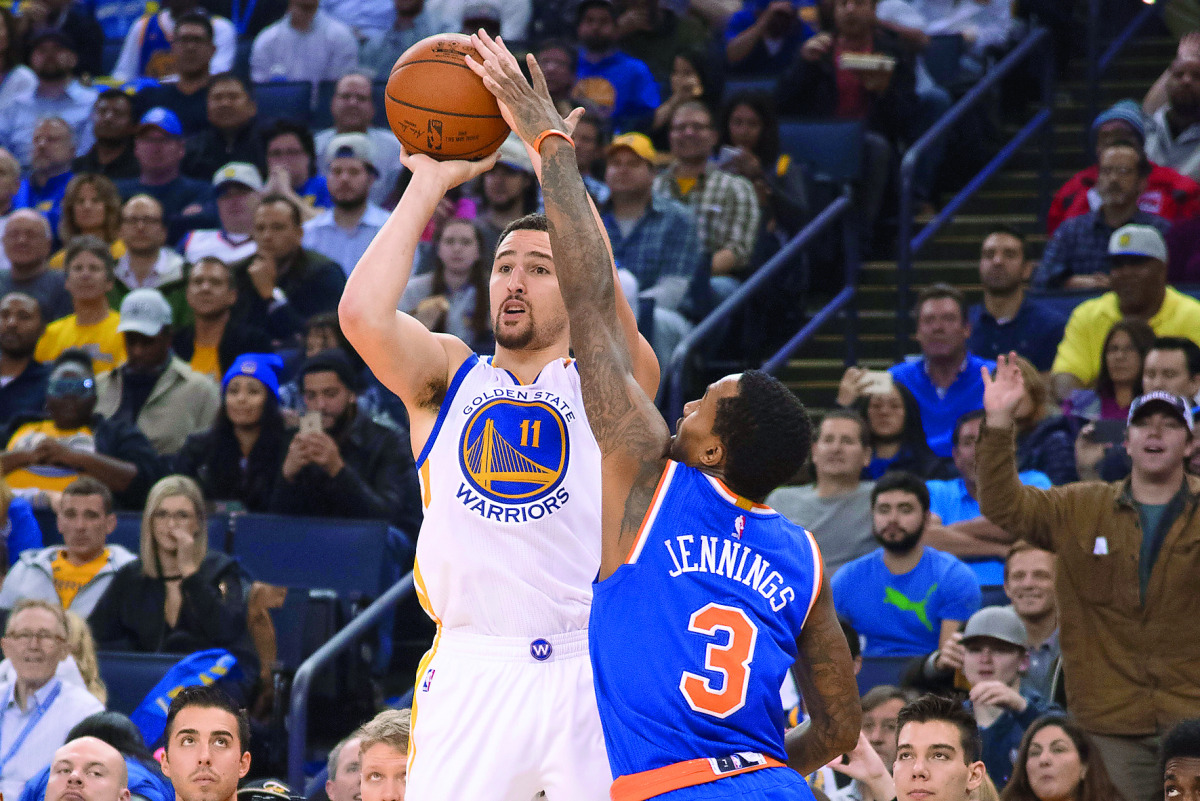 Golden State Warriors guard Klay Thompson (left) shoots the basketball against New York Knicks guard Brandon Jennings during the third quarter at Oracle Arena in Oakland, California, US yesterday.