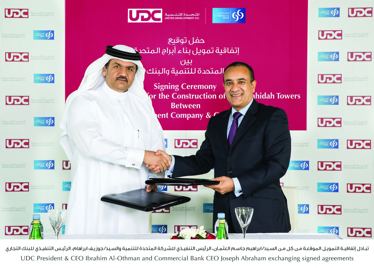 UDC President and CEO Ibrahim Al Othman (left), and Commercial Bank CEO Joseph Abraham shaking hands after signing the agreement at the Oyster building at The Pearl-Qatar.