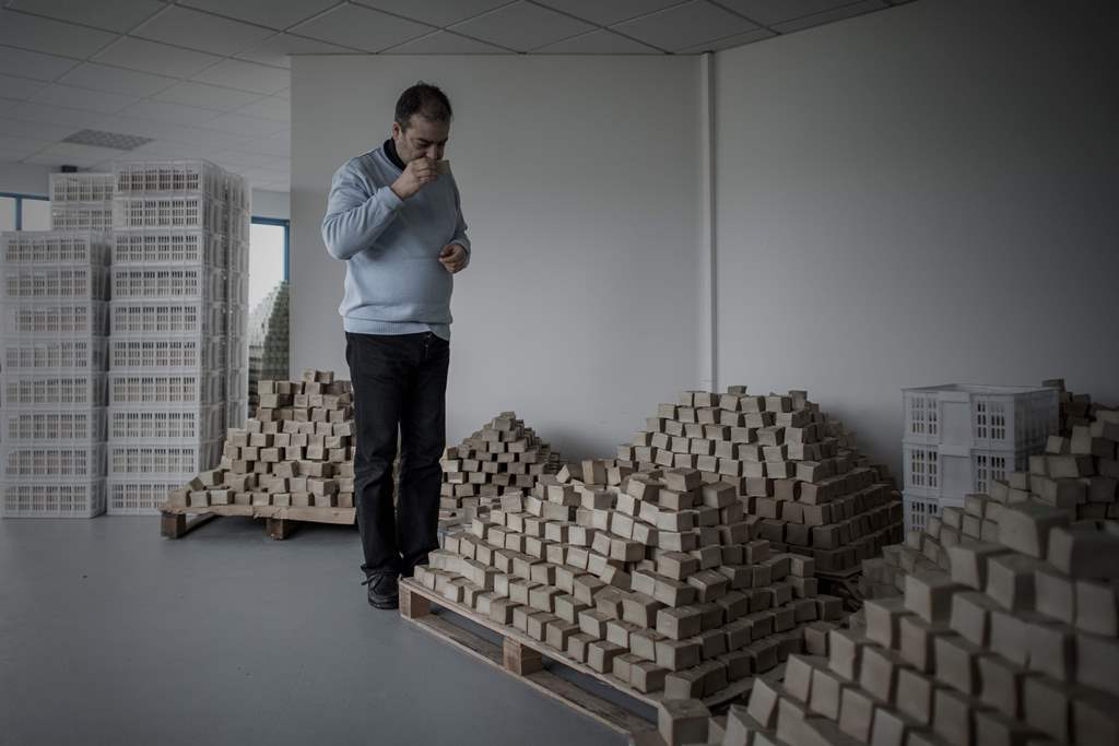 Samir Constantini, chief executive officer and founder of Aleppo soap company Alepia, smells a bar of soap in Santeny, 30kms from Paris, on December 19, 2016. AFP / PHILIPPE LOPEZ
