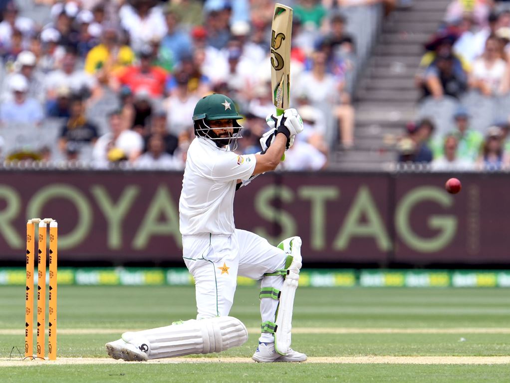 Pakistan batsman Azhar Ali drives a delivery on the way to scoring his double century against Australia on the third day of the second cricket Test match in Melbourne on December 28, 2016. AFP / WILLIAM WEST