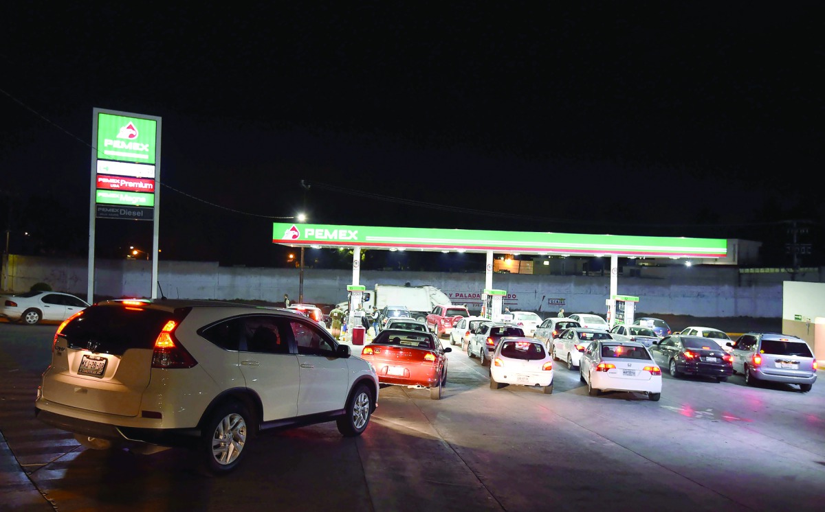 Cars wait at the petrol station in Cuautitlan Izcalli, Mexico. Mexico has announced double-digit price increases for petrol and diesel, its latest move to deregulate the energy sector and open the key oil industry to private investment and foreign competi
